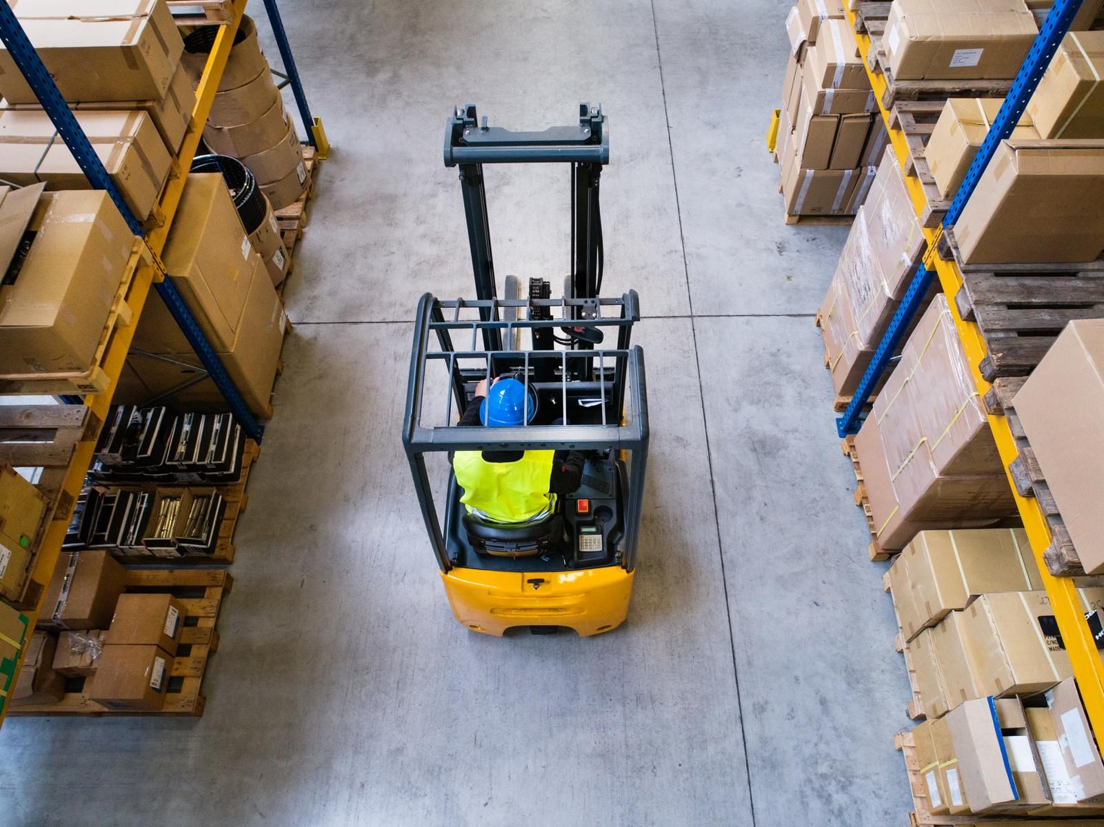 Bird's eye view of a forklift being operated by a man in a warehouse