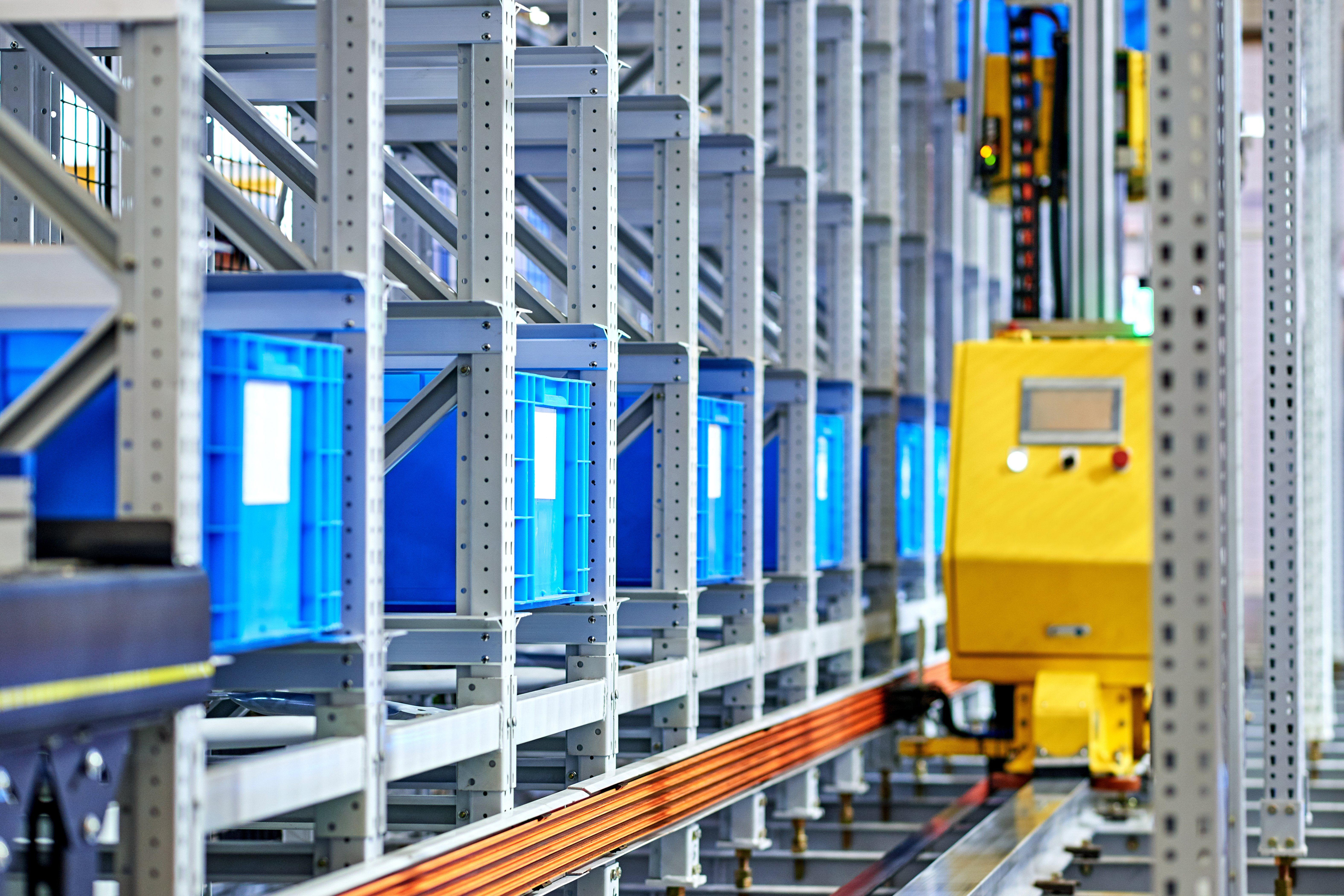 An AMR in a row of baskets in a warehouse