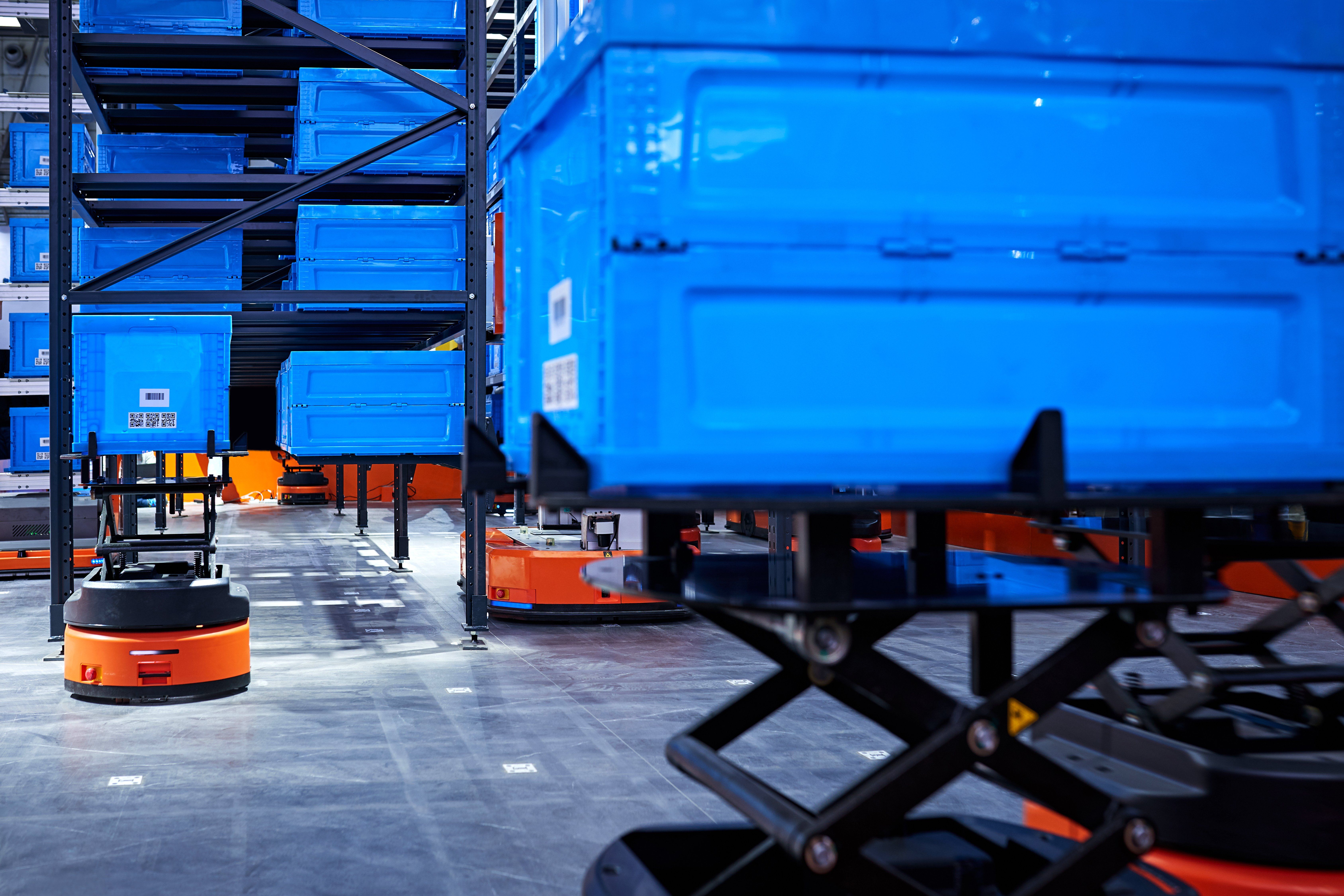 AGVs lifting crates in a warehouse