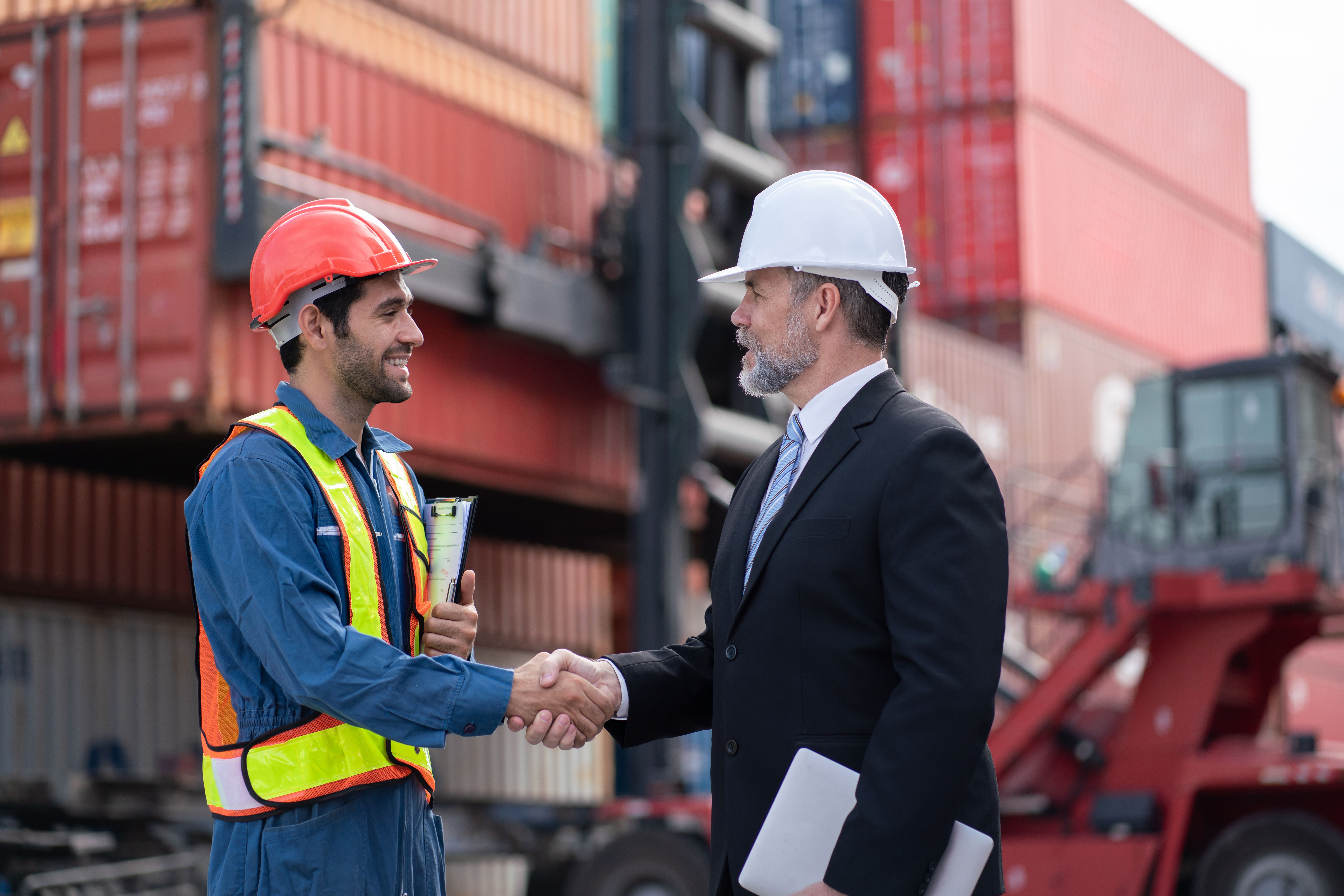 Two-People-Shaking-Hands-Making-a-deal-at-shipping-yard