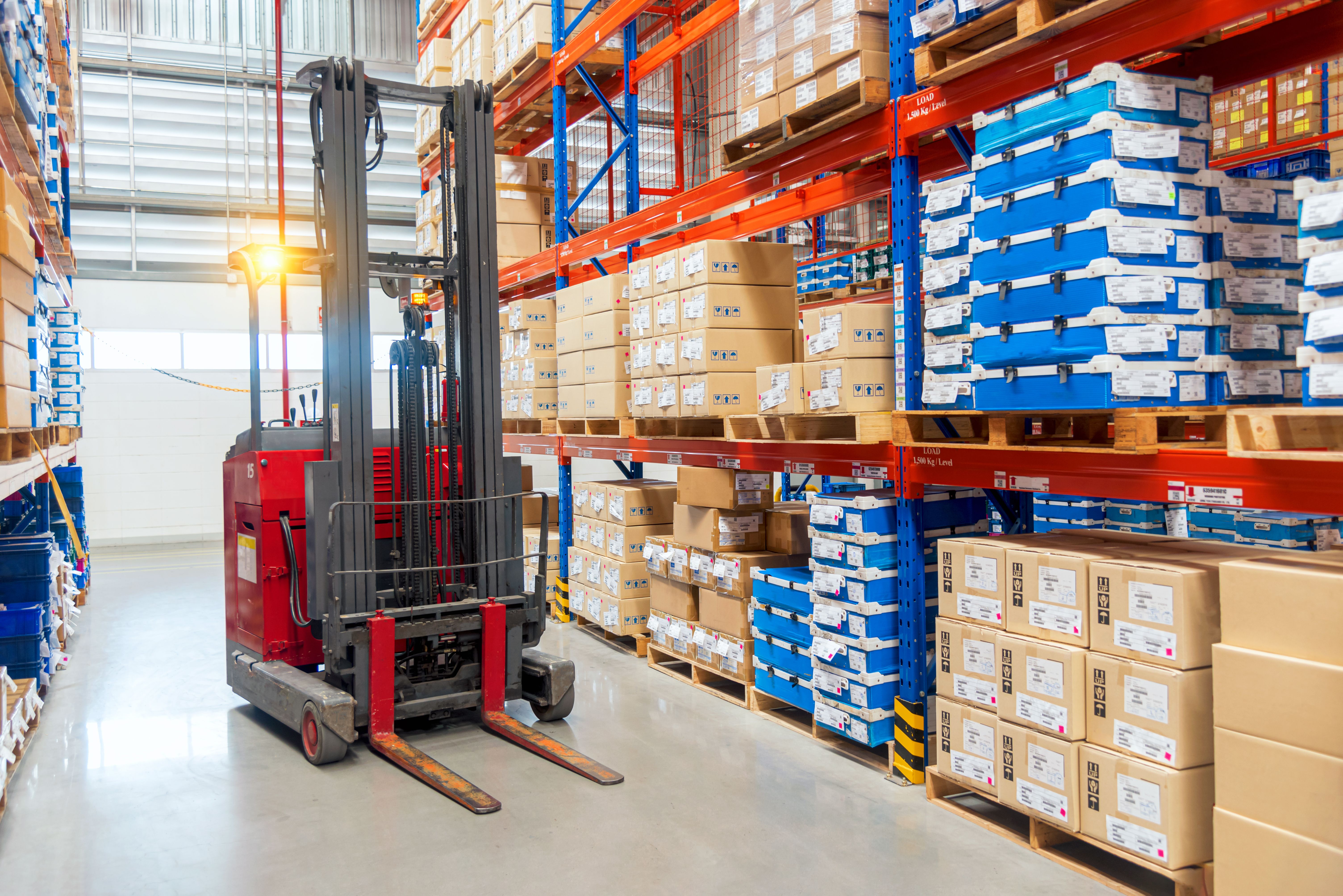Single forklift sitting in an aisle in a warehouse