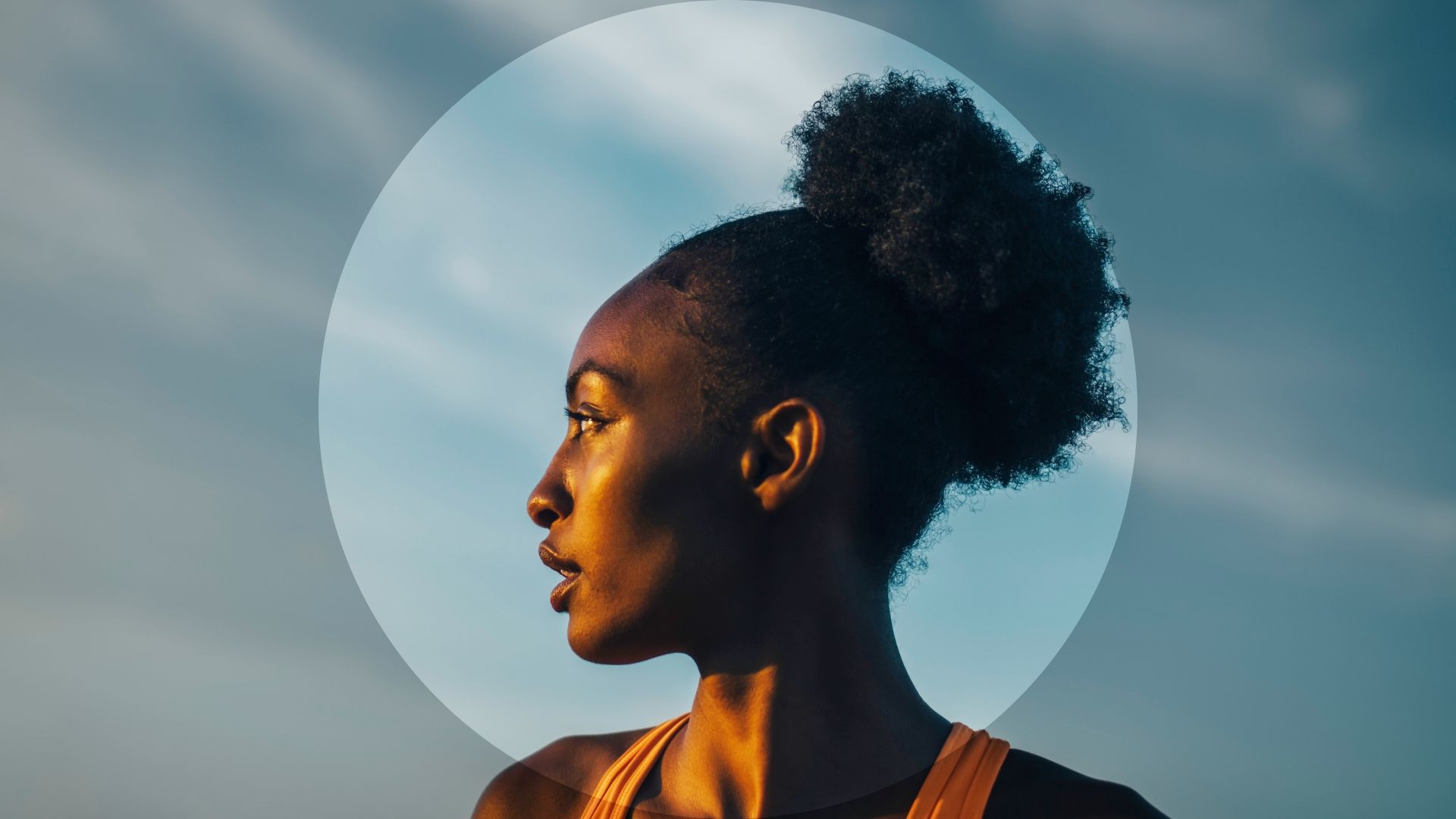 Side profile of a woman looking into the distance against a blue sky, with a translucent circle graphic overlay.