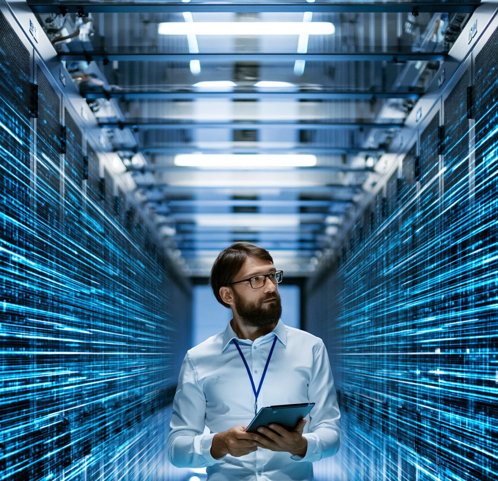 IT professional walking down a data center aisle