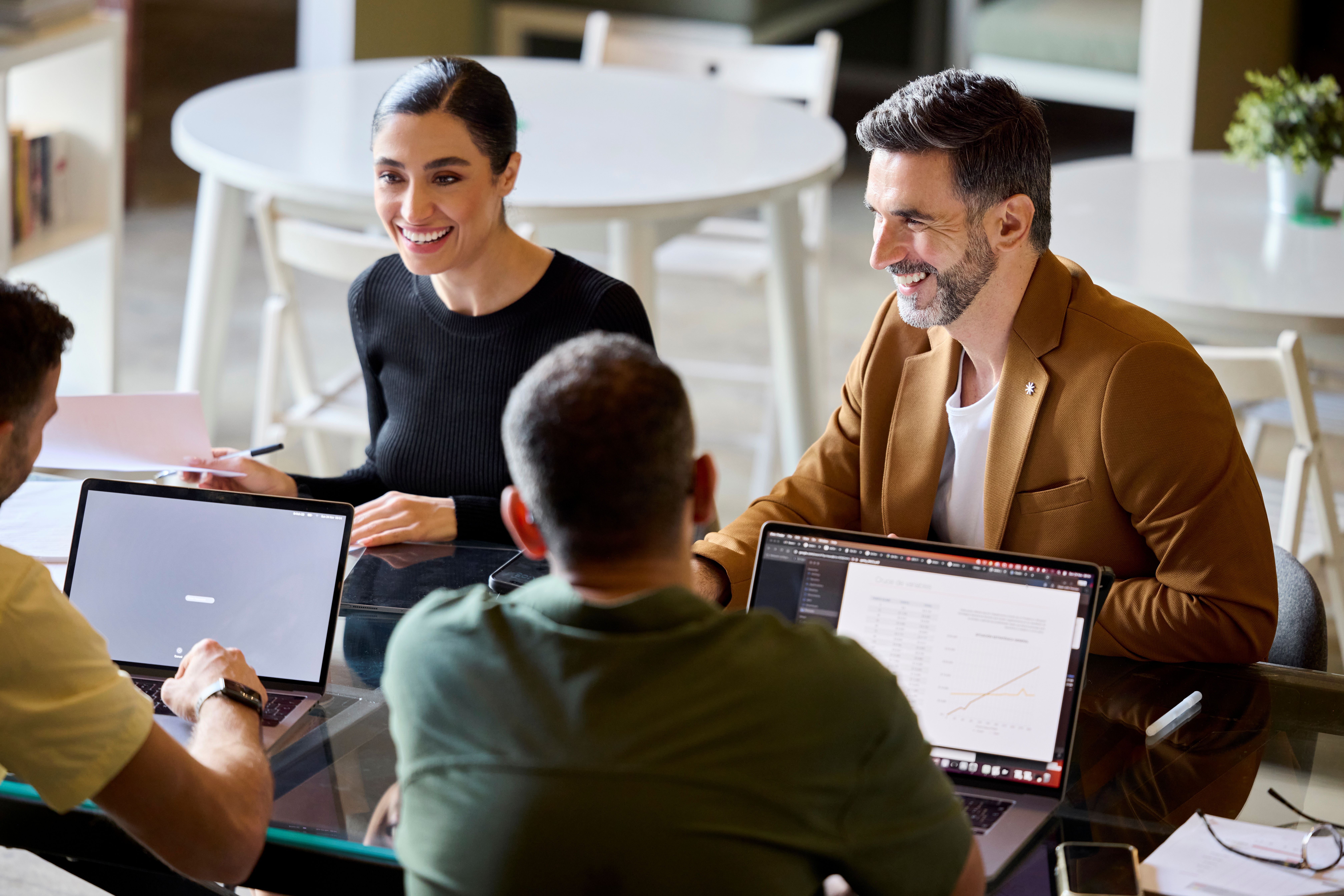 Group of IT people smiling and working together in a modern office space