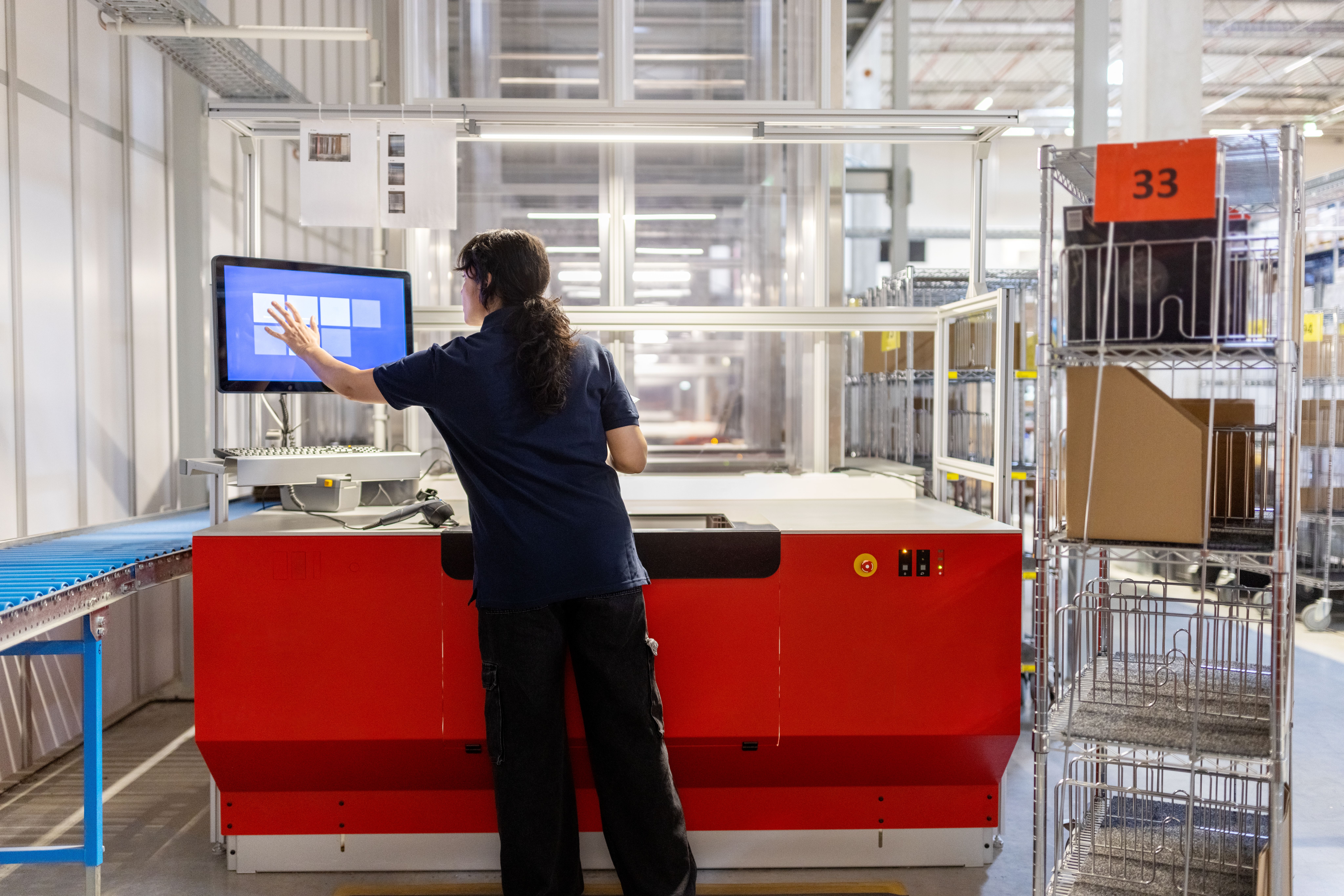 Woman tracking assets on a screen in a warehouse office