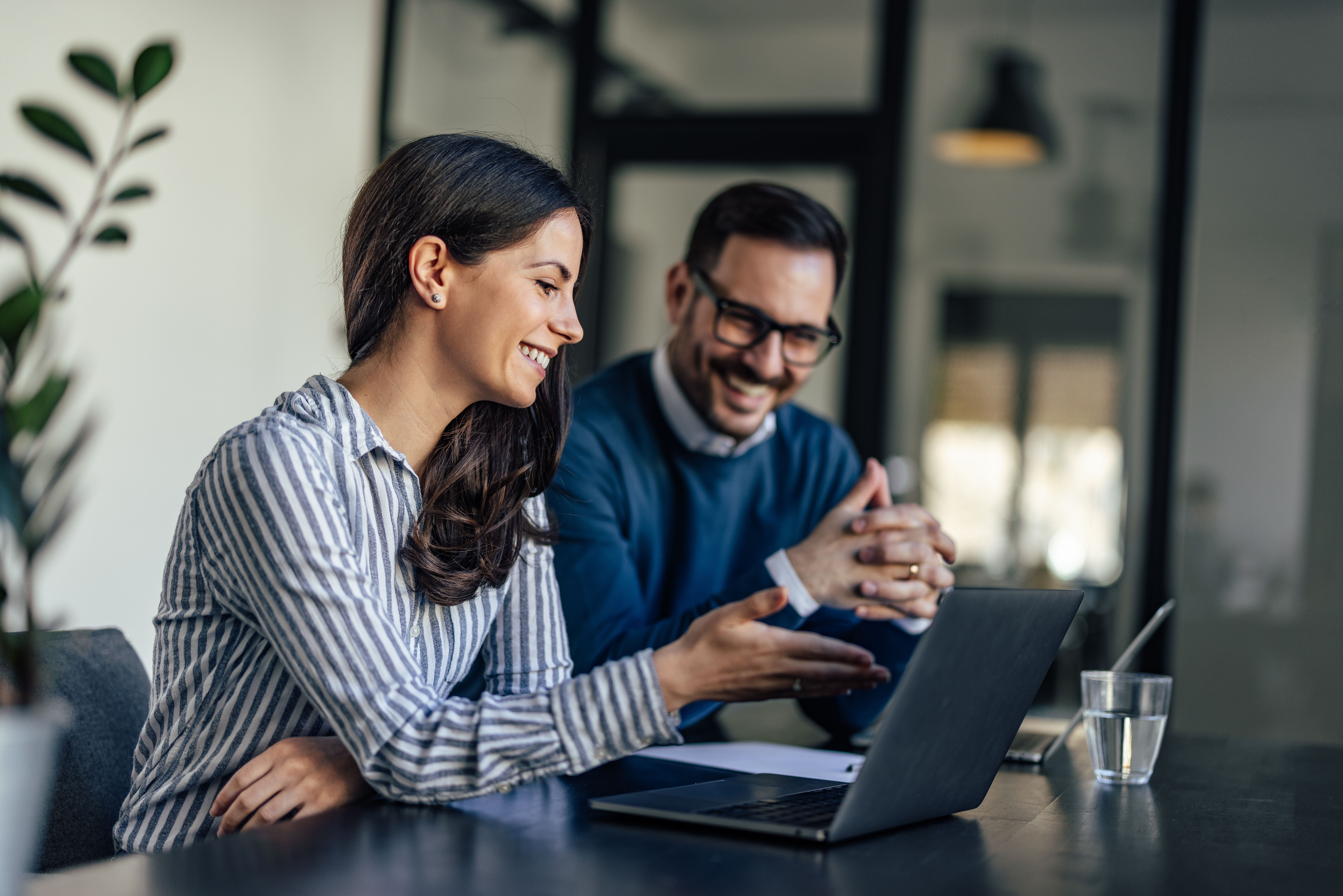 Two professional office workers talking in an office