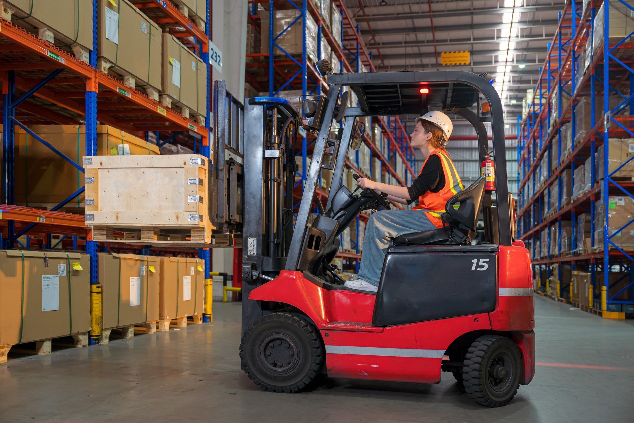 Person operating a forklift in a modern warehouse