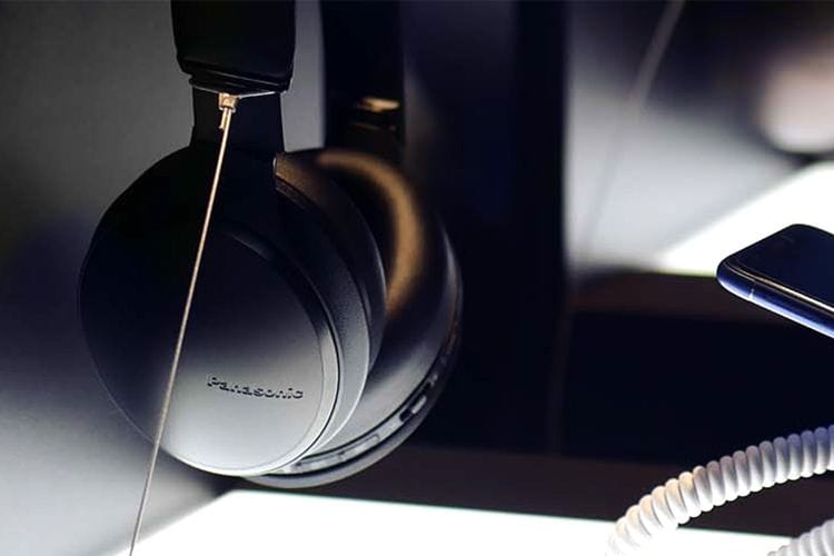 Close-up of black Panasonic over-ear headphones with a coiled cable