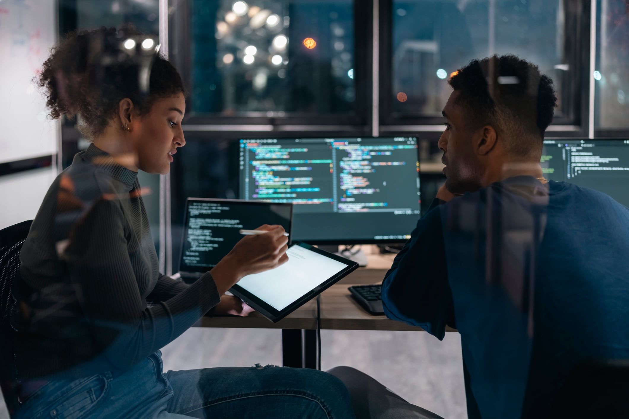 Two IT professionals working together at a desk